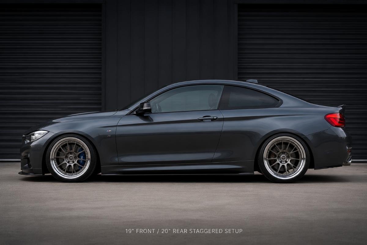 Side profile of a luxury coupe fitted with 19/20 staggered deep-lip wheel sets