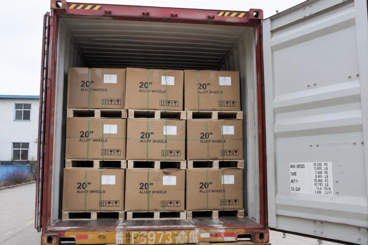 Bulk 20 inch rims loaded into a shipping container for cross-border delivery
